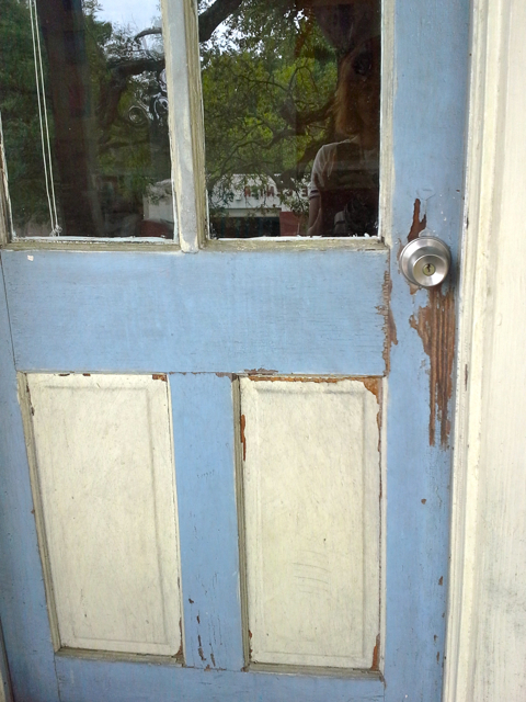 The ceiling and door to my porch. The entire ceiling is haint blue, though it is harder to see on an overcast day. The door trim provides a better example of haint blue in action.
